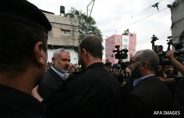 Palestinian prime minister in Gaza Strip, Ismail Haniya attends the funeral of Mohammed Al Kelani, a Hamas security officer, in Beit Lahiya, northern Gaza Strip, Monday, Nov. 14, 2011. Al Kelani was killed in an Israeli...