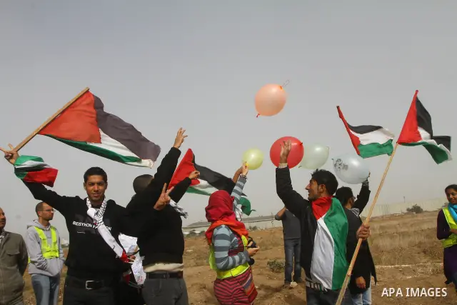Palestinian protesters wave national flags during a demonstration on Tuesday Nov. 15, 2011 on the outskirts of Gaza City to mark the 23rd anniversary of the Palestinian Independence Day. Palestinians have marked Nov. 15...