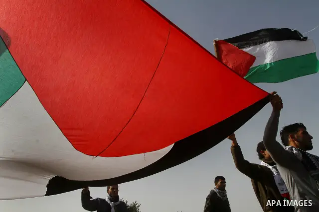 Palestinian protesters wave national flags during a demonstration on Tuesday Nov. 15, 2011 on the outskirts of Gaza City to mark the 23rd anniversary of the Palestinian Independence Day. Palestinians have marked Nov. 15...