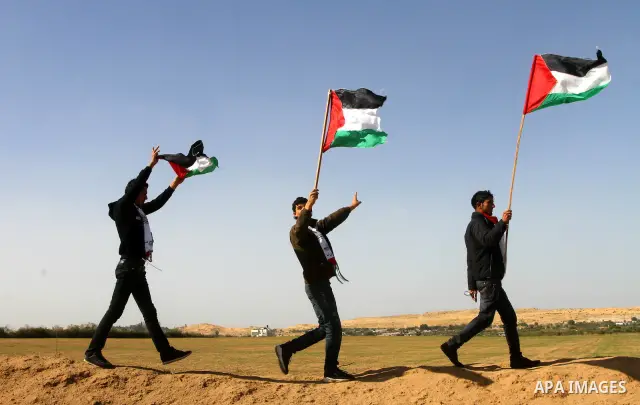 Palestinian protesters wave national flags during a demonstration on Tuesday Nov. 15, 2011 on the outskirts of Gaza City to mark the 23rd anniversary of the Palestinian Independence Day. Palestinians have marked Nov. 15...