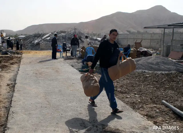 Palestinians check belongings scattered on the ground after Israeli bulldozers razed four Palestinian homes near the ancient city of Jericho on November 15, 2011 with Israel saying they endangered a nearby archaeological...