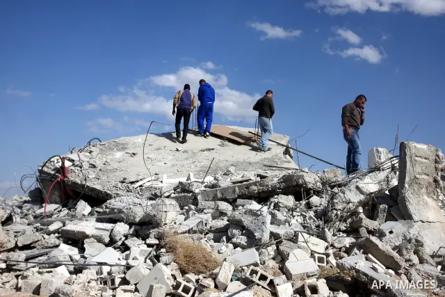 Palestinians check belongings scattered on the ground after Israeli bulldozers razed four Palestinian homes near the ancient city of Jericho on November 15, 2011 with Israel saying they endangered a nearby archaeological...