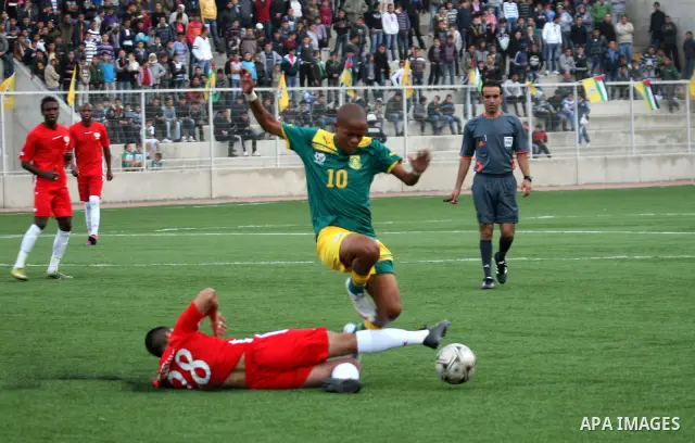 South African (Green) and Palestinian (Red) football players fight for the ball during football match in the West Bank town of Nablus, on Nov. 15, 2011. The match ended in 1-1draw. Photo by Wagdi Eshtayah