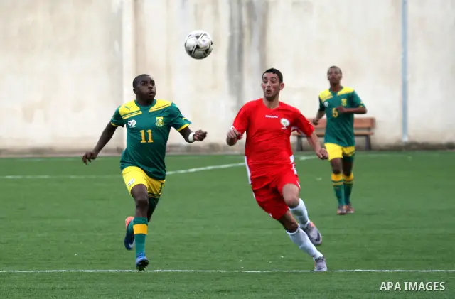 South African (Green) and Palestinian (Red) football players fight for the ball during football match in the West Bank town of Nablus, on Nov. 15, 2011. The match ended in 1-1draw. Photo by Wagdi Eshtayah