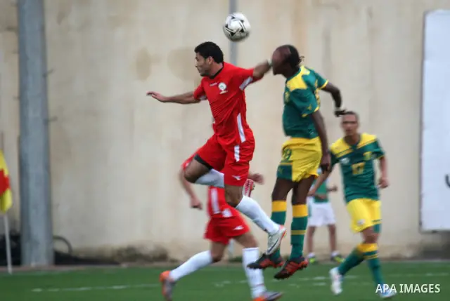 South African (Green) and Palestinian (Red) football players fight for the ball during football match in the West Bank town of Nablus, on Nov. 15, 2011. The match ended in 1-1draw. Photo by Wagdi Eshtayah