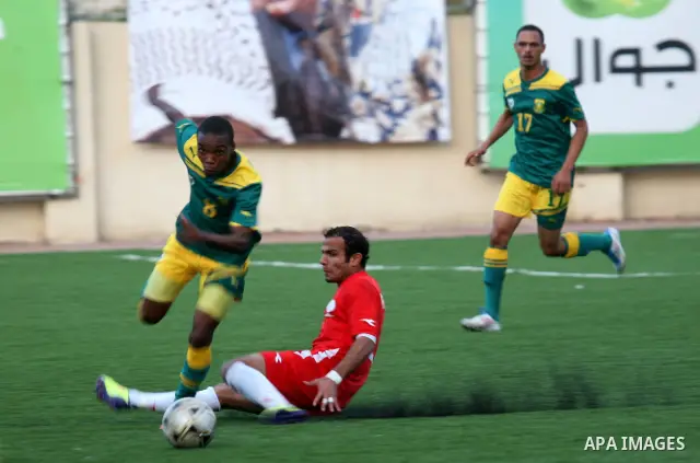 South African (Green) and Palestinian (Red) football players fight for the ball during football match in the West Bank town of Nablus, on Nov. 15, 2011. The match ended in 1-1draw. Photo by Wagdi Eshtayah