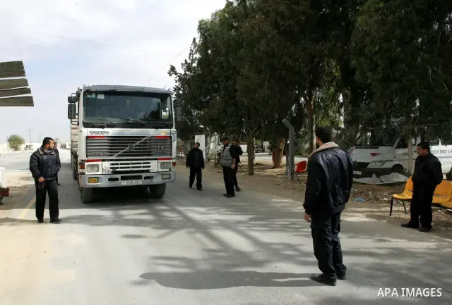 Palestinians check trucks loaded with construction materials at the Rafah crossing which entered through Israel's Kerem Shalom crossing in southern Gaza Strip on November 16, 2011. Israel allowed to enter the constructio...