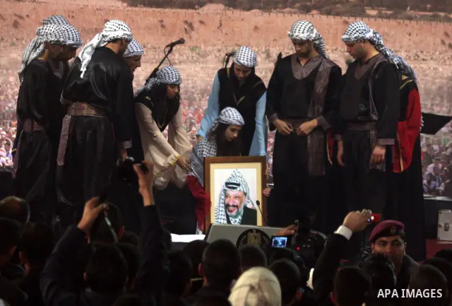 Supporters of the Palestinian President Mahmoud Abbas gather during his speech to the Palestinian leadership on November 16, 2011 in the West Bank city of Ramallah. The address was timed to mark seven years since the dea...