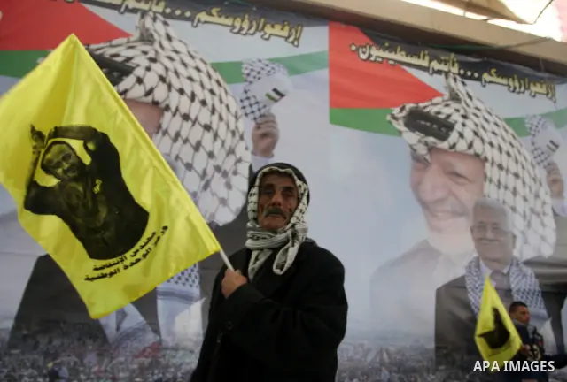 Supporters of the Palestinian President Mahmoud Abbas gather during his speech to the Palestinian leadership on November 16, 2011 in the West Bank city of Ramallah. The address was timed to mark seven years since the dea...
