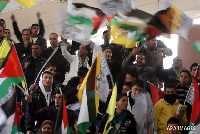 Supporters of the Palestinian President Mahmoud Abbas gather during his speech to the Palestinian leadership on November 16, 2011 in the West Bank city of Ramallah. The address was timed to mark seven years since the dea...
