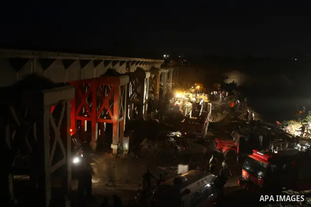 Palestinian rescue teams inspect the scene of a collapsed bridge on a main road in the central Gaza Strip that links Gaza City with the south, near Nusseirat, on November 17, 2011. Medical sources said two Palestinian wo...