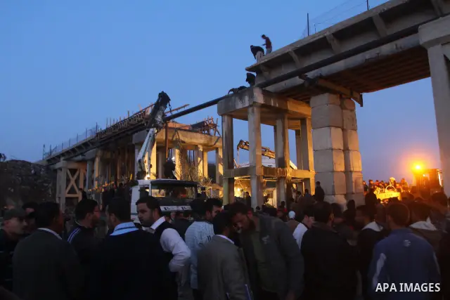 Palestinian rescue teams inspect the scene of a collapsed bridge on a main road in the central Gaza Strip that links Gaza City with the south, near Nusseirat, on November 17, 2011. Medical sources said two Palestinian wo...