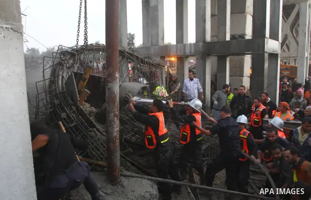 Palestinian rescue teams inspect the scene of a collapsed bridge on a main road in the central Gaza Strip that links Gaza City with the south, near Nusseirat, on November 17, 2011. Medical sources said two Palestinian wo...