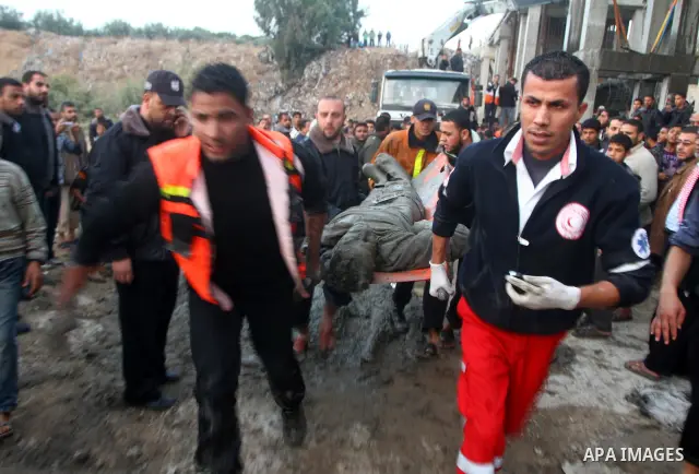 Palestinian rescue teams inspect the scene of a collapsed bridge on a main road in the central Gaza Strip that links Gaza City with the south, near Nusseirat, on November 17, 2011. Medical sources said two Palestinian wo...