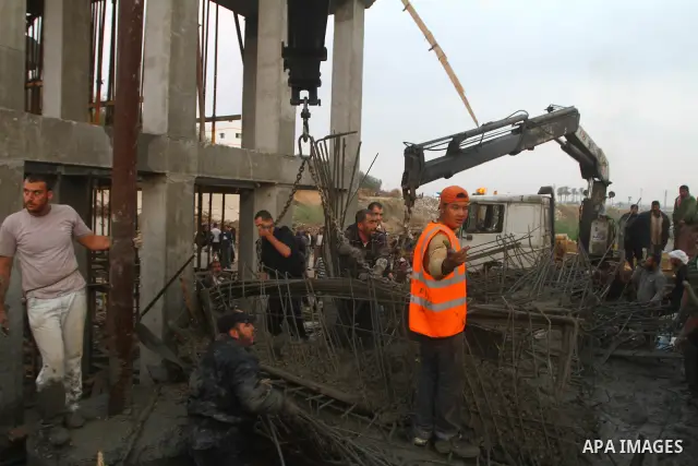 Palestinian rescue teams inspect the scene of a collapsed bridge on a main road in the central Gaza Strip that links Gaza City with the south, near Nusseirat, on November 17, 2011. Medical sources said two Palestinian wo...