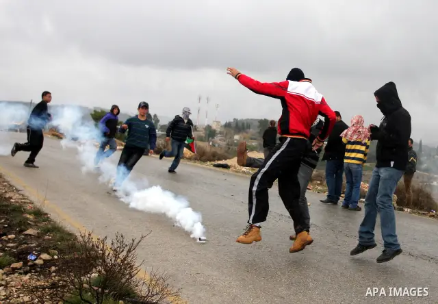 Palestinian youths and Israeli troops clash following a weekly demonstration against Israeli settlement expansion , in the West Bank village of Nabi Saleh, on November 18, 2011. Photo by Issam Rimawi