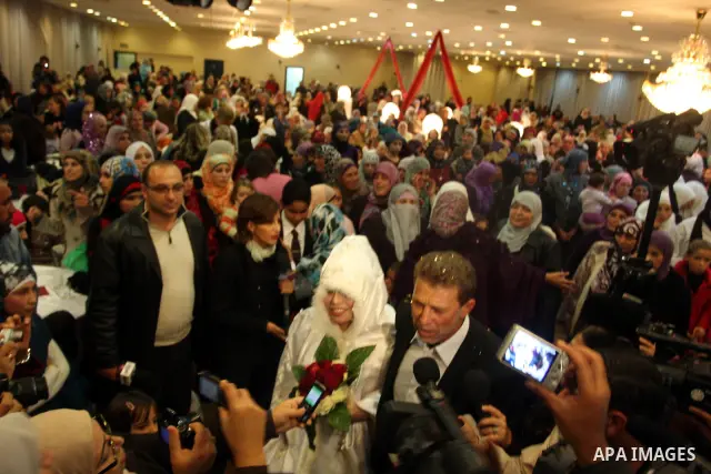 Palestinian freed prisoner Nael Barghouti and his bride Amal Nafea are greeted by relatives and friends during their wedding, in the West Bank city of Ramallah on Nov. 18,2011. Nael Barghouti released from the Israeli ja...