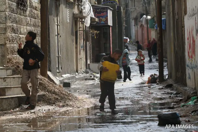 Palestinians walks through a flooded street after heavy rain and cold winds in Gaza City, On Nov. 19, 2011. Photo by Mohammed Asad