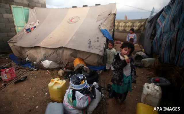 Palestinian bedouins sit inside their tent during heavy rain and cold winds in a camp for poor people in Al-Nussirat refugee camp, central Gaza Strip on 21 November 2011. Photo by Ali Jadallah