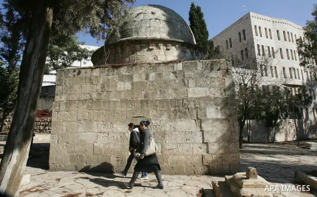 Palestinians inspect desecrated headstone at a Muslim graveyard in Jerusalem November 22, 2011. Israeli police launched an investigation into the desecration of headstones discovered, but believed to have happened severa...