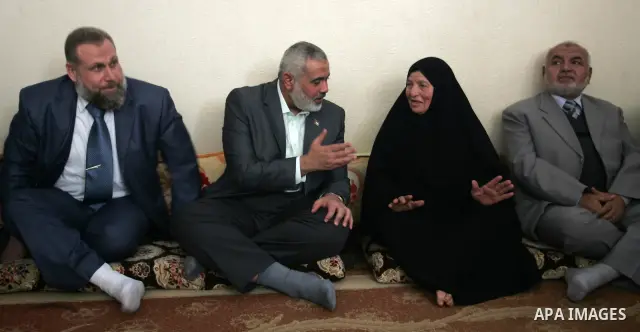 Palestinian Prime Minister in Gaza strip, Ismail Haniyeh sits with the mother of Ahmed al-Sheikh Khalil in the southern Gaza Strip town of Rafah on Nov. 22,2011. Ahmed al-Sheikh Khalil the commander of al-Quds Brigades t...