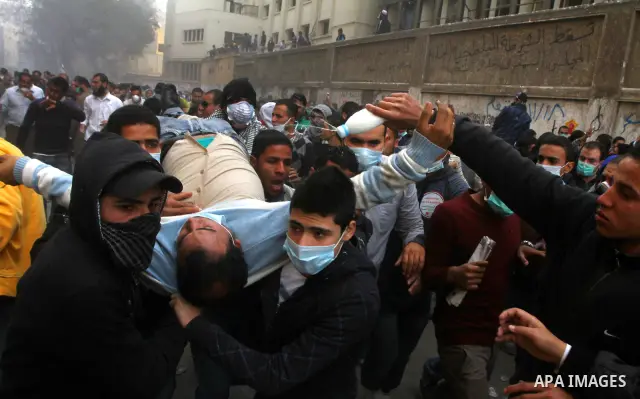 Egyptian protesters clash with riot police in a Cairo street on November 22, 2011. Thousands of protesters swarmed Cairo's Tahrir Square to demand an end to military rule, heightening tension after days of deadly clashes...