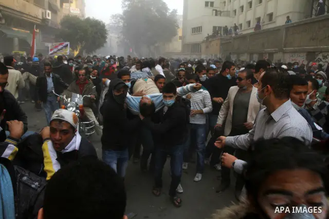 Egyptian protesters clash with riot police in a Cairo street on November 22, 2011. Thousands of protesters swarmed Cairo's Tahrir Square to demand an end to military rule, heightening tension after days of deadly clashes...
