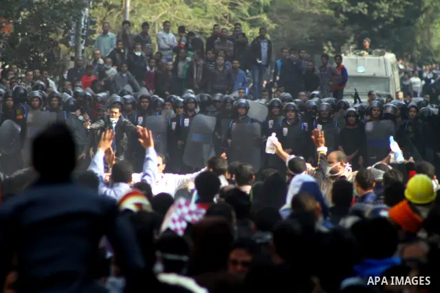 Egyptian protesters clash with riot police in a Cairo street on November 22, 2011. Thousands of protesters swarmed Cairo's Tahrir Square to demand an end to military rule, heightening tension after days of deadly clashes...