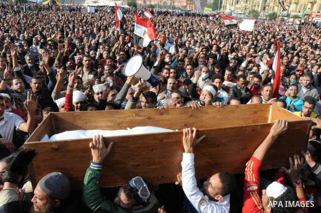 Protesters in Tahrir Square attend a funeral carrying the coffin of a protester who died in clashes with riot police, in Cairo November 22, 2011. Egyptians frustrated with military rule battled police in the streets agai...