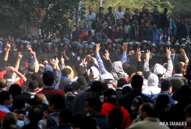 Egyptian protesters clash with riot police in a Cairo street. Thousands of protesters swarmed Cairo's Tahrir Square to demand an end to military rule, heightening tension after days of deadly clashes that threaten to der...
