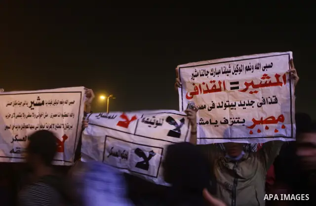 Protesters chant anti-military council slogans at Tahrir Square in Cairo November 22, 2011. Egypt's ruling generals offered on Tuesday to transfer power to a civilian president by July in a dramatic attempt to placate pr...
