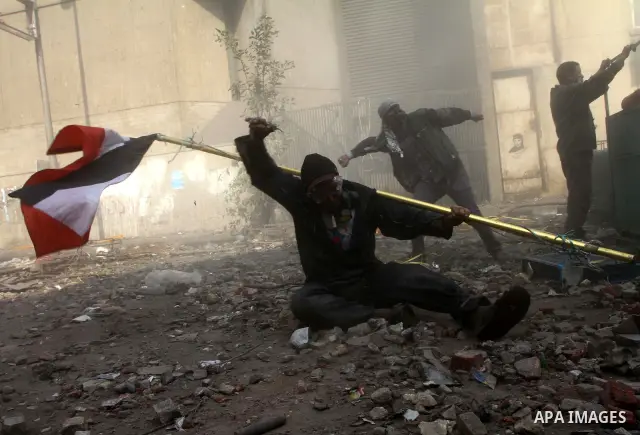 Egyptian protestors clash with riot police, not pictured, near Tahrir square in Cairo, Egypt, Wednesday, Nov. 23, 2011. Egyptian police are clashing with anti-government protesters for a fifth day in Cairo. Tens of thous...