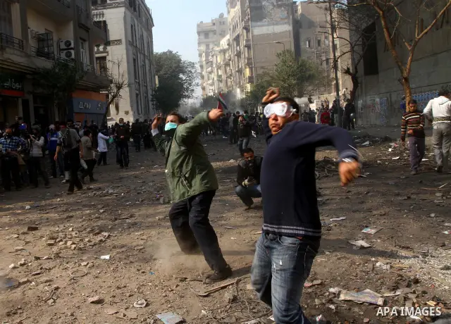 Egyptian protestors clash with riot police, not pictured, near Tahrir square in Cairo, Egypt, Wednesday, Nov. 23, 2011. Egyptian police are clashing with anti-government protesters for a fifth day in Cairo. Tens of thous...