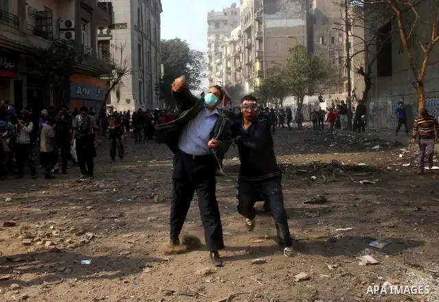 Egyptian protestors clash with riot police, not pictured, near Tahrir square in Cairo, Egypt, Wednesday, Nov. 23, 2011. Egyptian police are clashing with anti-government protesters for a fifth day in Cairo. Tens of thous...