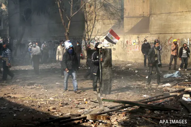 Egyptian protestors clash with riot police, not pictured, near Tahrir square in Cairo, Egypt, Wednesday, Nov. 23, 2011. Egyptian police are clashing with anti-government protesters for a fifth day in Cairo. Tens of thous...