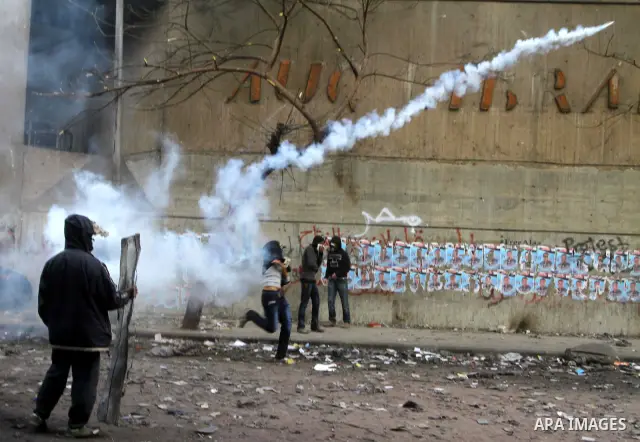 Egyptian protestors clash with riot police, not pictured, near Tahrir square in Cairo, Egypt, Wednesday, Nov. 23, 2011. Egyptian police are clashing with anti-government protesters for a fifth day in Cairo. Tens of thous...
