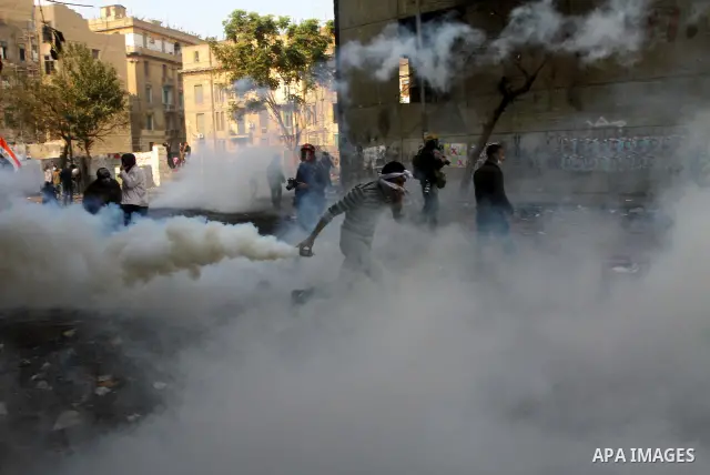 Egyptian protestors clash with riot police, not pictured, near Tahrir square in Cairo, Egypt, Wednesday, Nov. 23, 2011. Egyptian police are clashing with anti-government protesters for a fifth day in Cairo. Tens of thous...