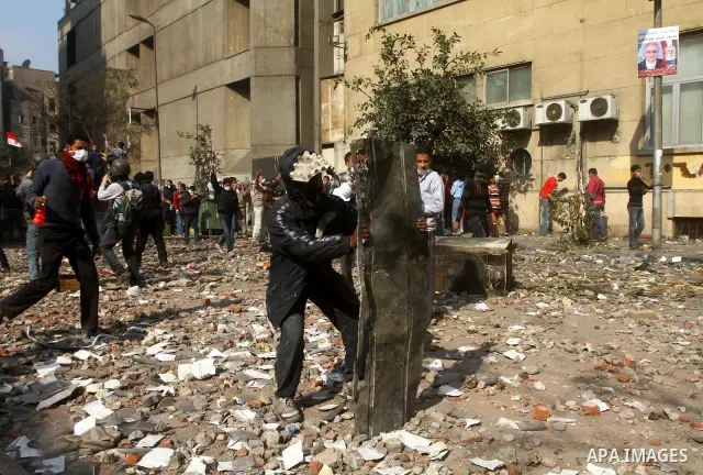 Egyptian protestors clash with riot police, not pictured, near Tahrir square in Cairo, Egypt, Wednesday, Nov. 23, 2011. Egyptian police are clashing with anti-government protesters for a fifth day in Cairo. Tens of thous...