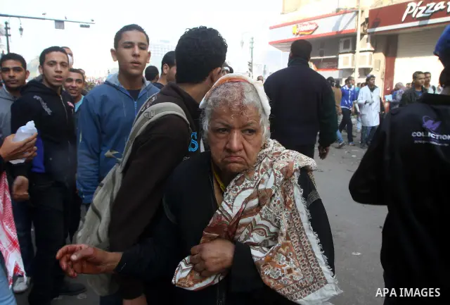 Protesters help another protester injured during clashes with riot police near Tahrir square in Cairo, Egypt, Wednesday, Nov. 23, 2011. Egyptian police are clashing with anti-government protesters for a fifth day in Cair...