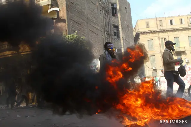Egyptian protestors clash with riot police, not pictured, near Tahrir square in Cairo, Egypt, Wednesday, Nov. 23, 2011. Egyptian police are clashing with anti-government protesters for a fifth day in Cairo. Tens of thous...