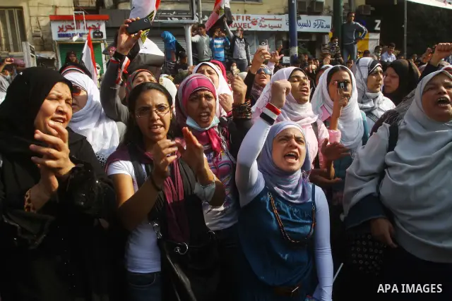 Protesters gather on Tahrir square as clashes against the anti-riot police are underway nearby in the street leading to the ministry of interior in Cairo, Egypt, Wednesday, Nov. 23, 2011. Tens of thousands of protesters...