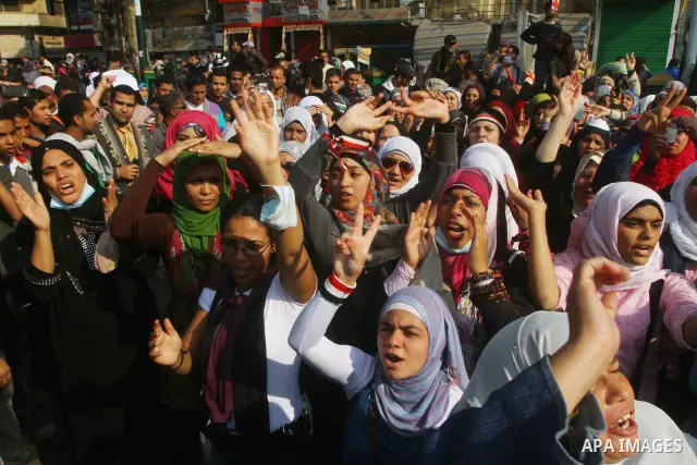Protesters gather on Tahrir square as clashes against the anti-riot police are underway nearby in the street leading to the ministry of interior in Cairo, Egypt, Wednesday, Nov. 23, 2011. Tens of thousands of protesters...