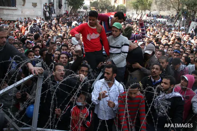 Egyptian protesters gather near barbed wire and concrete barricades around the Interior Ministry, near Cairo's Tahrir Square, November 24, 2011. A truce between Egyptian riot police and protesters succeeded on Thursday i...
