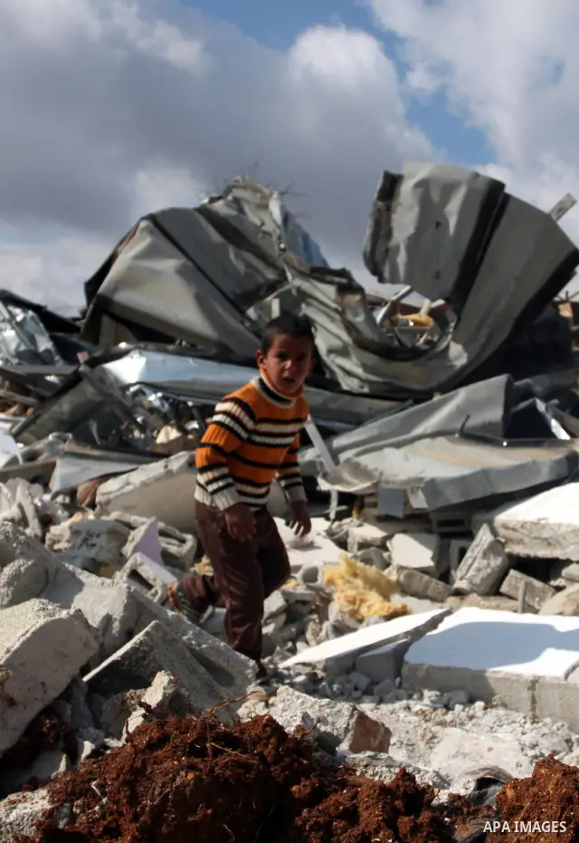 Palestinians from the Bedouin Abu Mansor family stand on the rubble after Israeli forces destroyed their family house in an area of the east Jerusalem neighborhood of Beit Hanina which falls in the West Bank side of Isra...