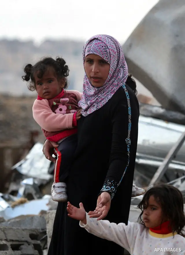 Palestinians from the Bedouin Abu Mansor family stand on the rubble after Israeli forces destroyed their family house in an area of the east Jerusalem neighborhood of Beit Hanina which falls in the West Bank side of Isra...