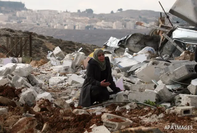 Palestinians from the Bedouin Abu Mansor family stand on the rubble after Israeli forces destroyed their family house in an area of the east Jerusalem neighborhood of Beit Hanina which falls in the West Bank side of Isra...