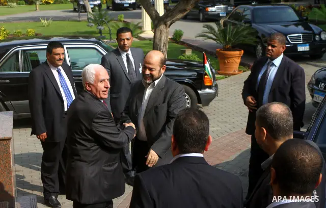 Senior Hamas leader Mousa Abu Marzouk meets with top Fatah official Azzam al-Ahmed in Cairo on November 24, 2011. Abbas and Meshaal hailed a new Palestinian "partnership" after talks to implement a landmark reconciliatio...
