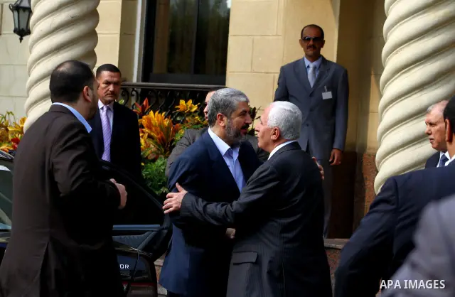 Hamas chief Khaled Meshaal meets with top Fatah official Azzam al-Ahmed in Cairo on November 24, 2011. Abbas and Meshaal hailed a new Palestinian "partnership" after talks to implement a landmark reconciliation deal. Pho...
