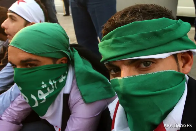 Pro-reform supporters protest outside the Arab League headquarters in the Egyptian capital Cairo, where a ministerial meeting on Syria was held on November 24, 2011. Arab foreign ministers have invited Syria to sign an a...