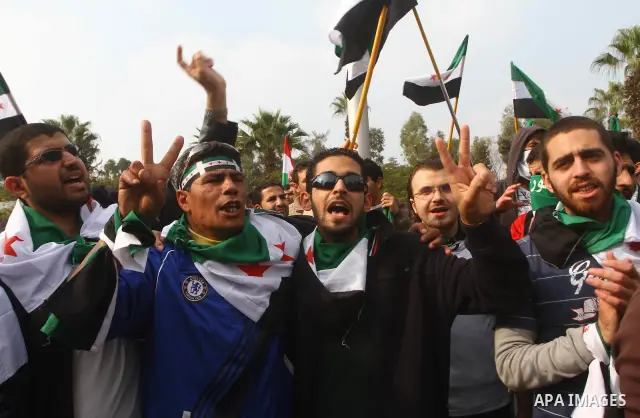 Pro-reform supporters protest outside the Arab League headquarters in the Egyptian capital Cairo, where a ministerial meeting on Syria was held on November 24, 2011. Arab foreign ministers have invited Syria to sign an a...